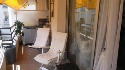 two white chairs in a room with a window at 1 mn CROISETTE près Martinez in Cannes