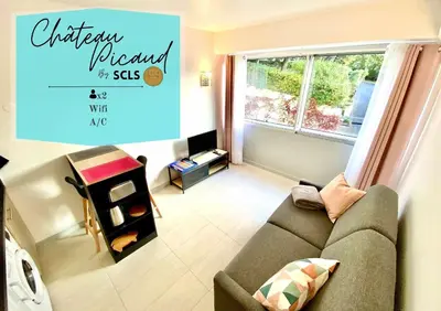 a small living room with a couch and a window at Château Picaud By SCLS Locations in Cannes