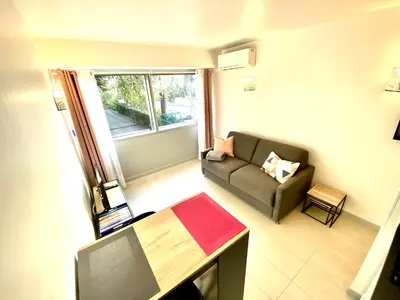 a small living room with a couch and a window at Château Picaud By SCLS Locations in Cannes