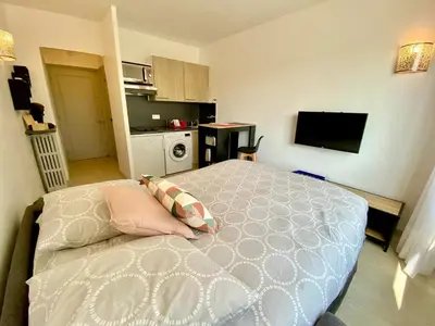 a small bedroom with a bed and a kitchen at Château Picaud By SCLS Locations in Cannes