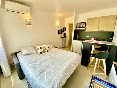 a small bedroom with a bed and a kitchen at Château Picaud By SCLS Locations in Cannes