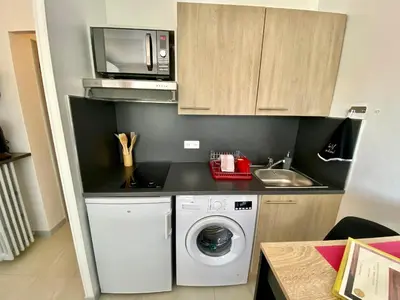 a kitchen with a washing machine and a microwave at Château Picaud By SCLS Locations in Cannes