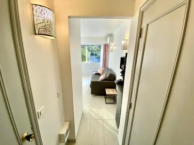 a hallway leading to a living room with a couch at Château Picaud By SCLS Locations in Cannes