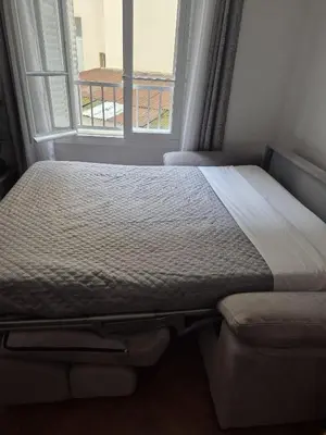 a bed in a room with a window at Appartement Bellarosa in Cannes