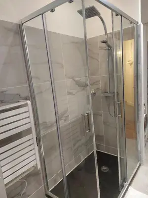 a shower with glass doors in a bathroom at Appartement Bellarosa in Cannes