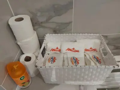 a basket of toilet paper and toilet paper rolls at Appartement Bellarosa in Cannes