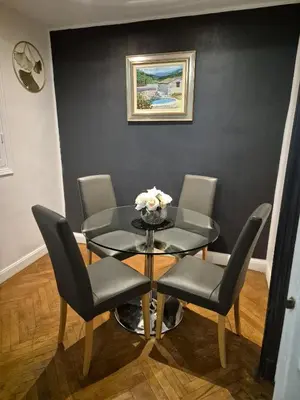 a dining room with a glass table and chairs at Appartement Bellarosa in Cannes