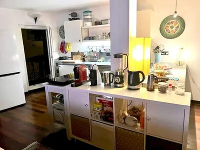 a kitchen with a white counter top in a room at Le Port Luxury Loft Duplex in Cannes