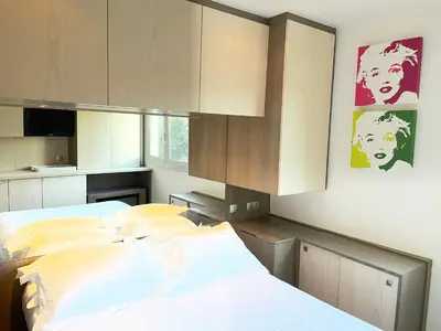 a bedroom with two beds and some cabinets at Chambre idéalement située à 50m de la Croisette in Cannes