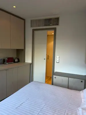 a bedroom with a bed and a door to a kitchen at Chambre idéalement située à 50m de la Croisette in Cannes