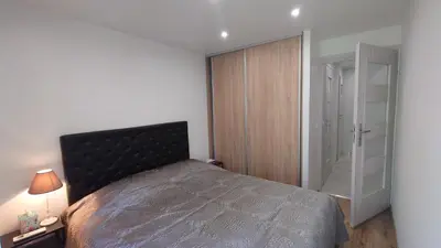 a bedroom with a bed and a sliding glass door at Magnifique appartement à 10mn du Palais in Cannes