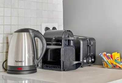 a toaster sitting on a counter next to a coffee maker at 3 chambres - Marché Forville - Proche du Palais in Cannes