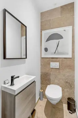a bathroom with a toilet and a sink and a mirror at 3 chambres - Marché Forville - Proche du Palais in Cannes
