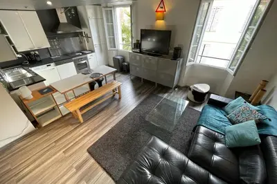 a living room with a couch and a kitchen at Riouffe 2 bedroom duplex apartment in the center of Cannes in Cannes