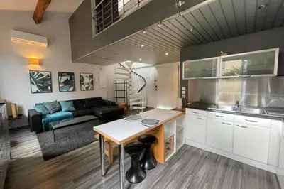 a kitchen and living room with a table and a couch at Riouffe 2 bedroom duplex apartment in the center of Cannes in Cannes