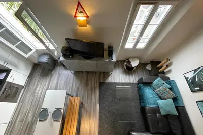 a living room with a couch and a tv at Riouffe 2 bedroom duplex apartment in the center of Cannes in Cannes