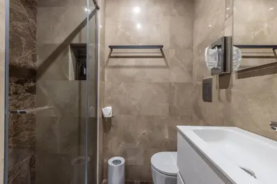 a bathroom with a shower and a toilet and a sink at LB Vacation Rentals I Deluxe Studio w Balcony - 5mn Center I Casa d'Azur in Cannes