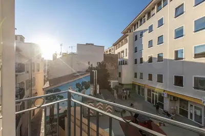 a view of a city street from a balcony at LB Vacation Rentals I Deluxe Studio w Balcony - 5mn Center I Casa d'Azur in Cannes