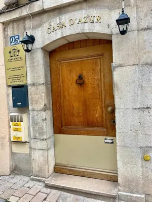 a wooden door on the side of a building at LB Vacation Rentals I Deluxe Studio w Balcony - 5mn Center I Casa d'Azur in Cannes