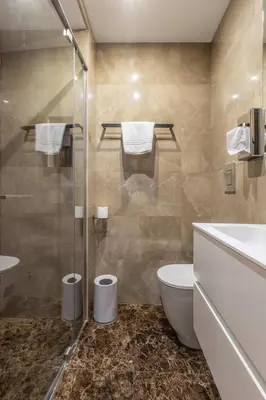 a bathroom with a toilet and a glass shower at LB Vacation Rentals I Large Superieure Room with Balcony I Casa d'Azur in Cannes