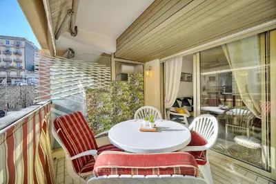 a balcony with a white table and chairs at Le Kate-500m Plage-Terrasse Verrière Côte d’Azur in Cannes