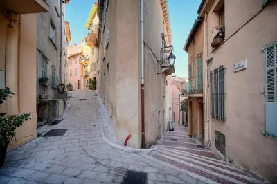 an empty street in an alley with buildings at IMMOGROOM - Refurbished - Suquet - Sea view in Cannes