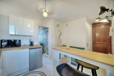 a kitchen with a counter top and a microwave at IMMOGROOM - Refurbished - Suquet - Sea view in Cannes