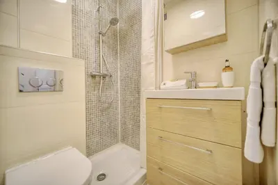 a bathroom with a shower and a toilet and a sink at IMMOGROOM - Refurbished - Suquet - Sea view in Cannes