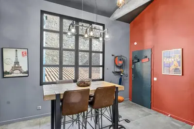 a bedroom with a large white bed and a bathroom at Magnifique Loft industriel, forville, centre de Cannes  in Cannes