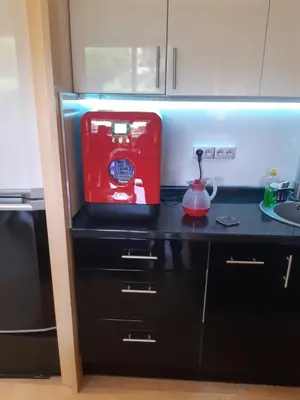a kitchen with a red sewing machine on a counter at IDEAL POUR COUPLE in Cannes
