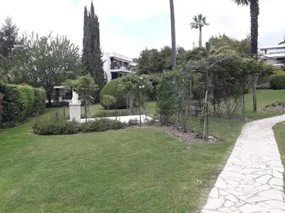 a garden with trees and a walkway at IDEAL POUR COUPLE in Cannes