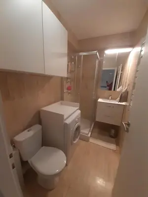 a bathroom with a white toilet and a sink at IDEAL POUR COUPLE in Cannes