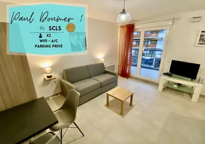 a living room with a couch and a tv at PAUL DOUMER #1 By SCLS Locations in Le Cannet