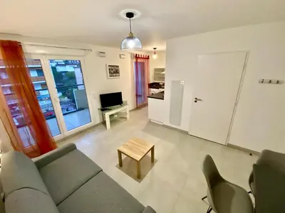 a living room with a couch and a table at PAUL DOUMER #1 By SCLS Locations in Le Cannet