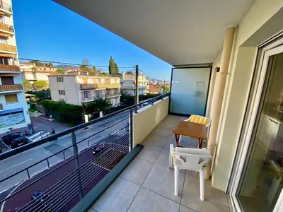 a balcony with a table and a chair and a view at PAUL DOUMER #1 By SCLS Locations in Le Cannet