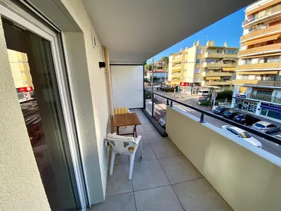 a balcony with a table and a view of a city at PAUL DOUMER #1 By SCLS Locations in Le Cannet