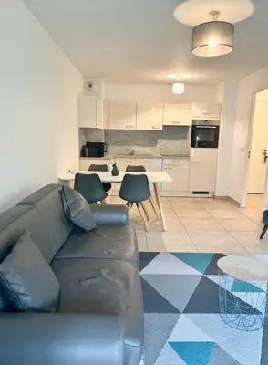 a living room with a couch and a kitchen at Oxford 1-bedroom apartment in a new building with pool and parking in Cannes