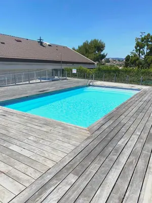 a swimming pool on top of a wooden deck at Oxford 1-bedroom apartment in a new building with pool and parking in Cannes