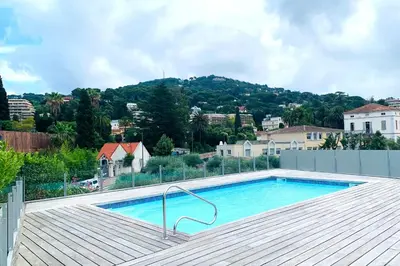 a swimming pool on the roof of a house at Oxford 1-bedroom apartment in a new building with pool and parking in Cannes