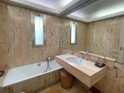 a bathroom with a bath tub and a sink at 2 bedroom apartment with parking 3 mins from La Croisette beach in Cannes