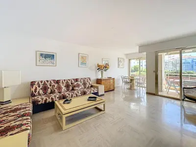 a living room with a couch and a table at 2 bedroom apartment with parking 3 mins from La Croisette beach in Cannes