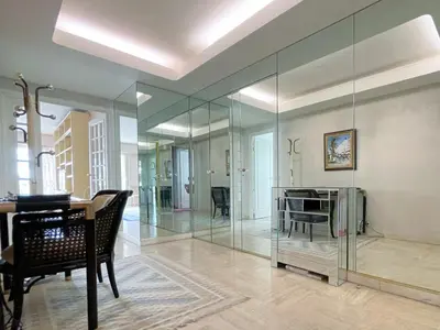 a large glass room with a table and chairs at 2 bedroom apartment with parking 3 mins from La Croisette beach in Cannes