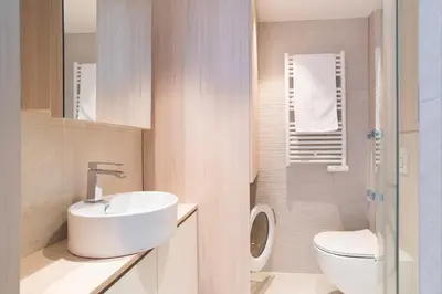 a bathroom with a white sink and a toilet at 1-Br Apartment Sea View Terrace & Parking in Cannes
