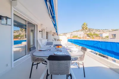 a table and chairs on a balcony with a view at 1-Br Apartment Sea View Terrace & Parking in Cannes