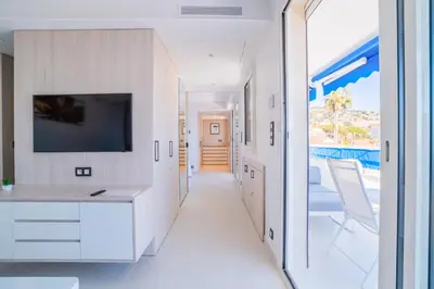 a hallway of a house with a view of a pool at 1-Br Apartment Sea View Terrace & Parking in Cannes