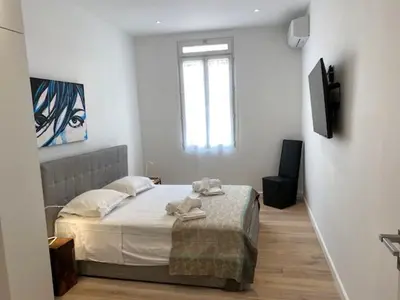 a bedroom with a bed with towels on it at M.M.R. Au cœur de la vie cannoise in Cannes