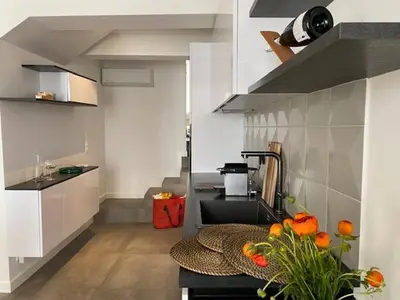a kitchen with a sink and a counter with oranges on it at M.M.R. Au cœur de la vie cannoise in Cannes