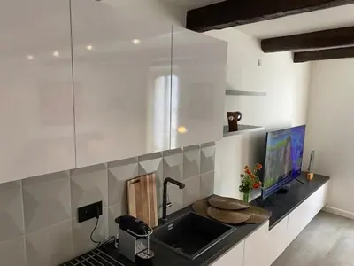 a kitchen with a sink and a laptop on a counter at M.M.R. Au cœur de la vie cannoise in Cannes