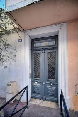 a blue door on the side of a building at IMMOGROOM - Cosy Studio - Forville market - AC in Cannes