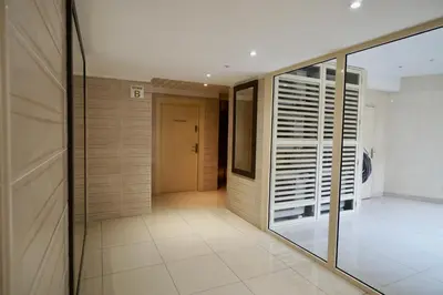 a room with a glass door and a hallway at Apartment Montaigne in Cannes